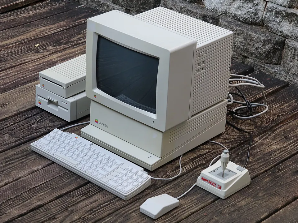 An Apple IIGS with its monitor, keyboard, mouse and disk drives.
