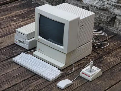 An Apple IIGS with its monitor, keyboard, mouse and disk drives.