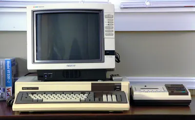 An NEC PC-8801 computer with monitor and disk drive.